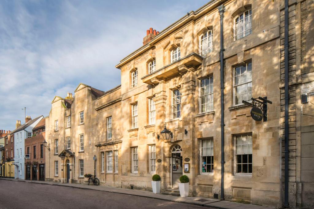 a large stone building on a street at Vanbrugh House Hotel in Oxford