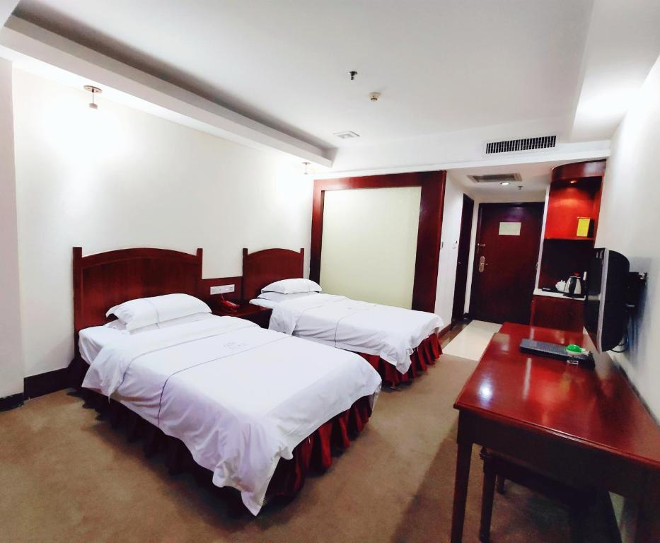 Postel nebo postele na pokoji v ubytování Guangzhou Junshan Hotel - Shuttle bus for Canton Fair