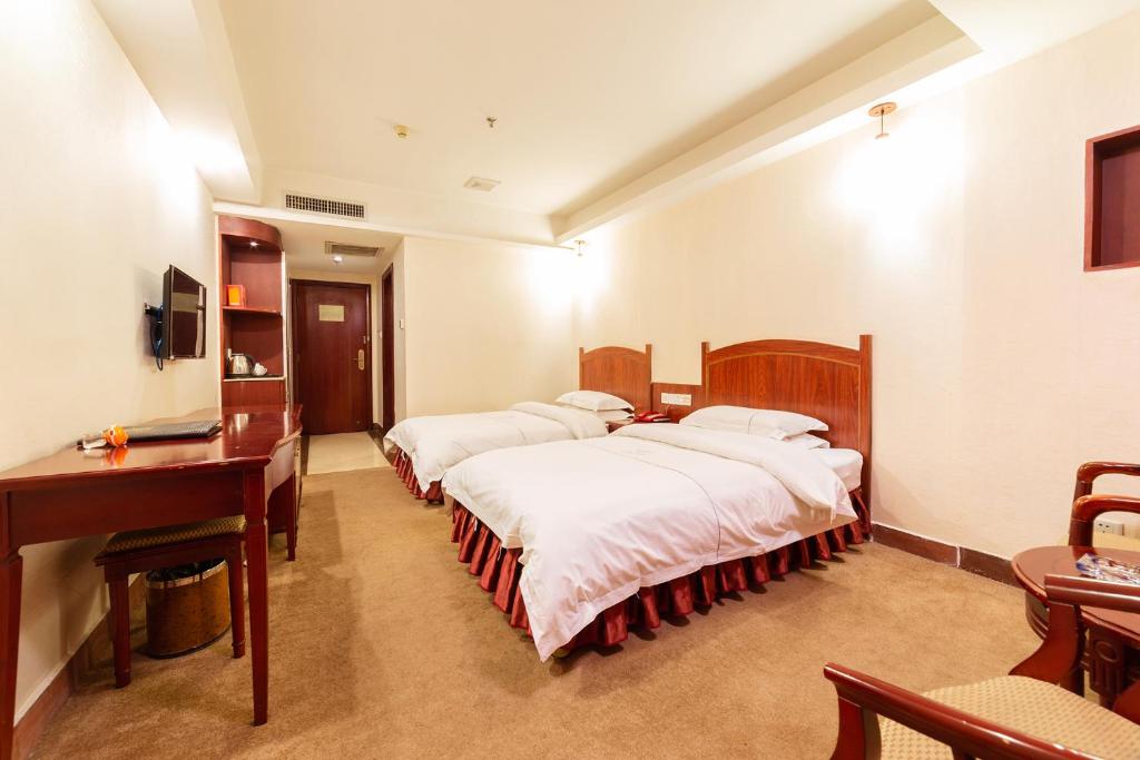 Postel nebo postele na pokoji v ubytování Guangzhou Junshan Hotel - Shuttle bus for Canton Fair