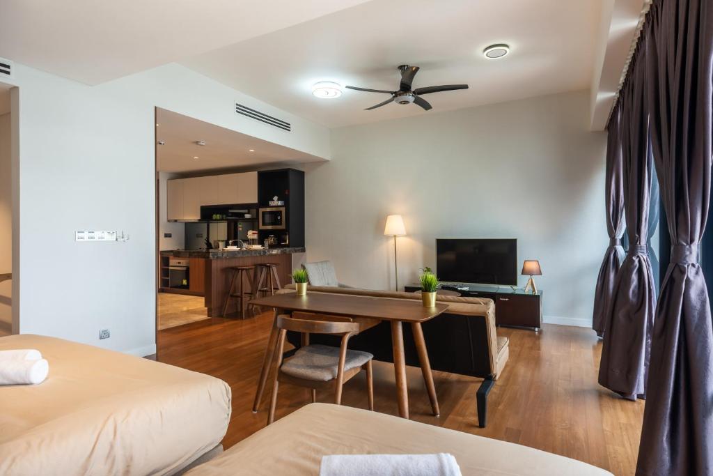 a bedroom with a desk and a living room at Anggun Residences Luxe in Kuala Lumpur