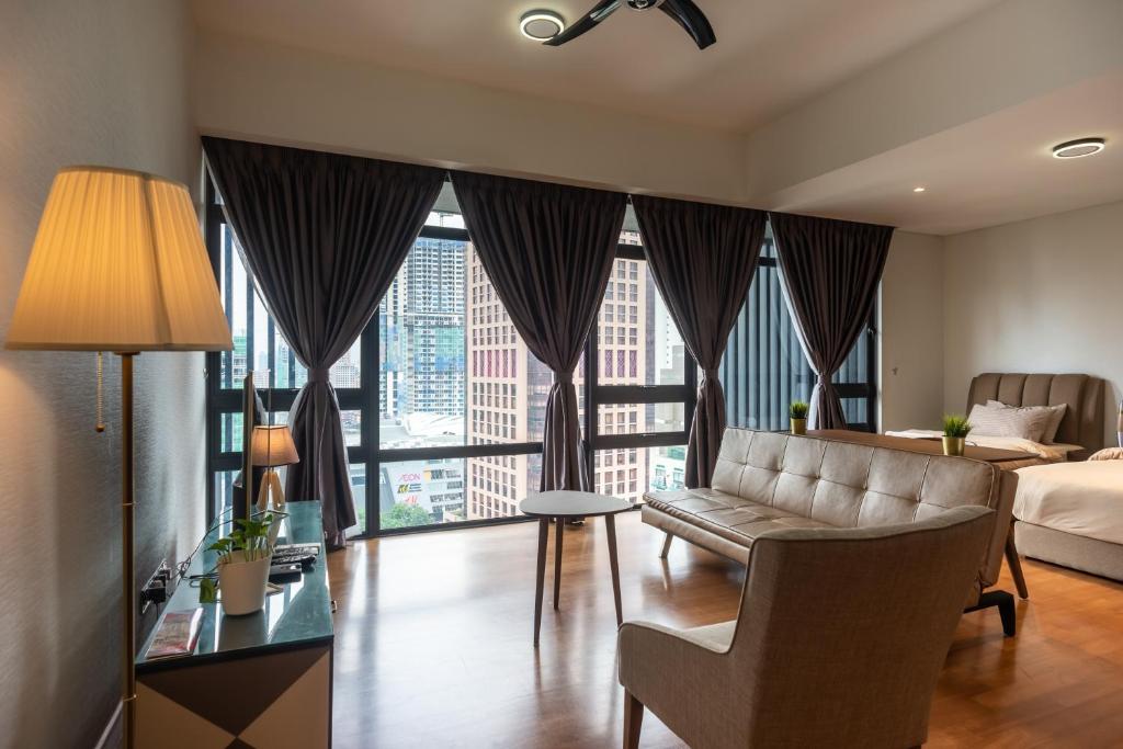a hotel room with a bed and a large window at Anggun Residences Luxe in Kuala Lumpur