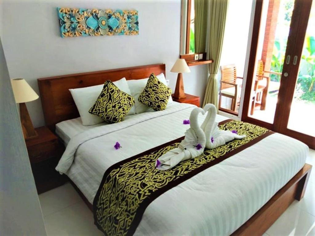 Postel nebo postele na pokoji v ubytování BatanTop Ubud guest house