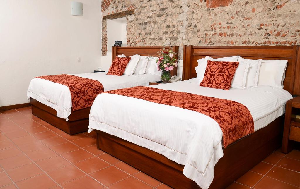 Ένα ή περισσότερα κρεβάτια σε δωμάτιο στο El Serafin Hotel Boutique