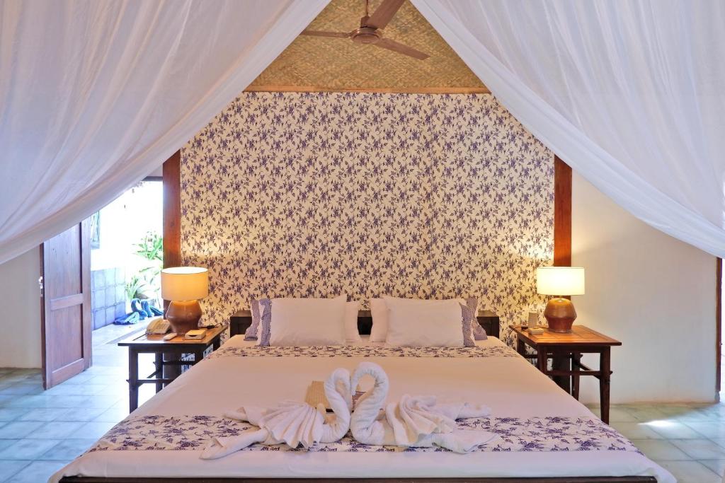 Letto o letti in una camera di D'omah Yogya Hotel