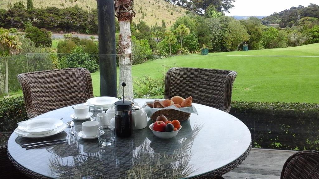 a table with a bowl of fruit on top of it at Pukeko Nest in Russell