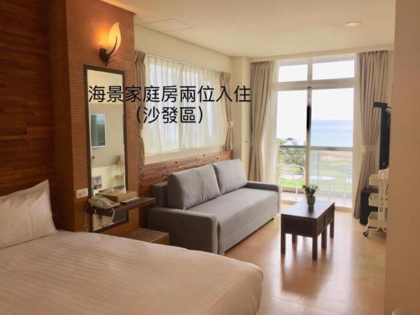 a hotel room with a bed and a couch at LoveSea 126 Beach Inn in Kenting