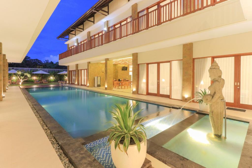 a villa with a swimming pool at night at Linda Villa 2 in Sanur