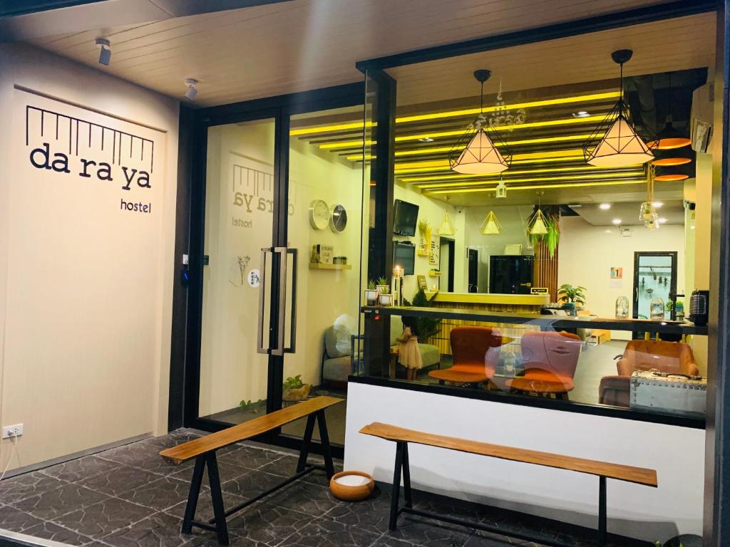 a store window with a bench in a room at Daraya Hostel in Bangkok