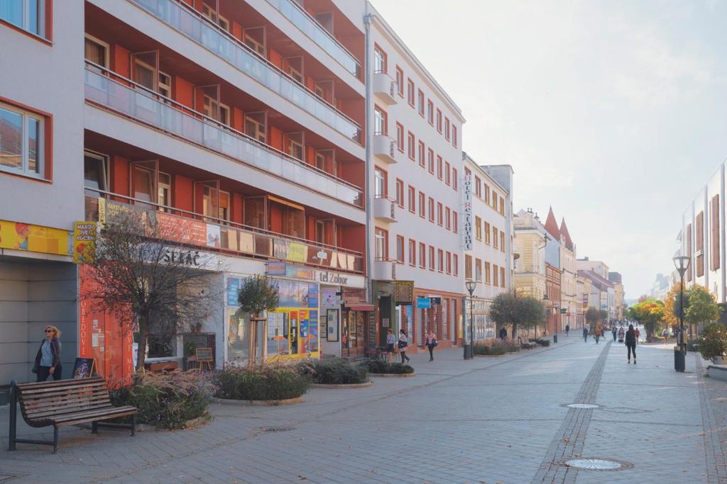 an empty street in a city with buildings at Hotel Zobor in Nitra