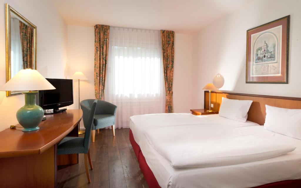 A bed or beds in a room at Wyndham Garden Hennigsdorf Berlin