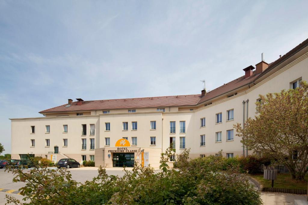 Un gran edificio blanco con un cartel en él. en Première Classe Marne la Vallée - Bussy Saint Georges, en Bussy-Saint-Georges