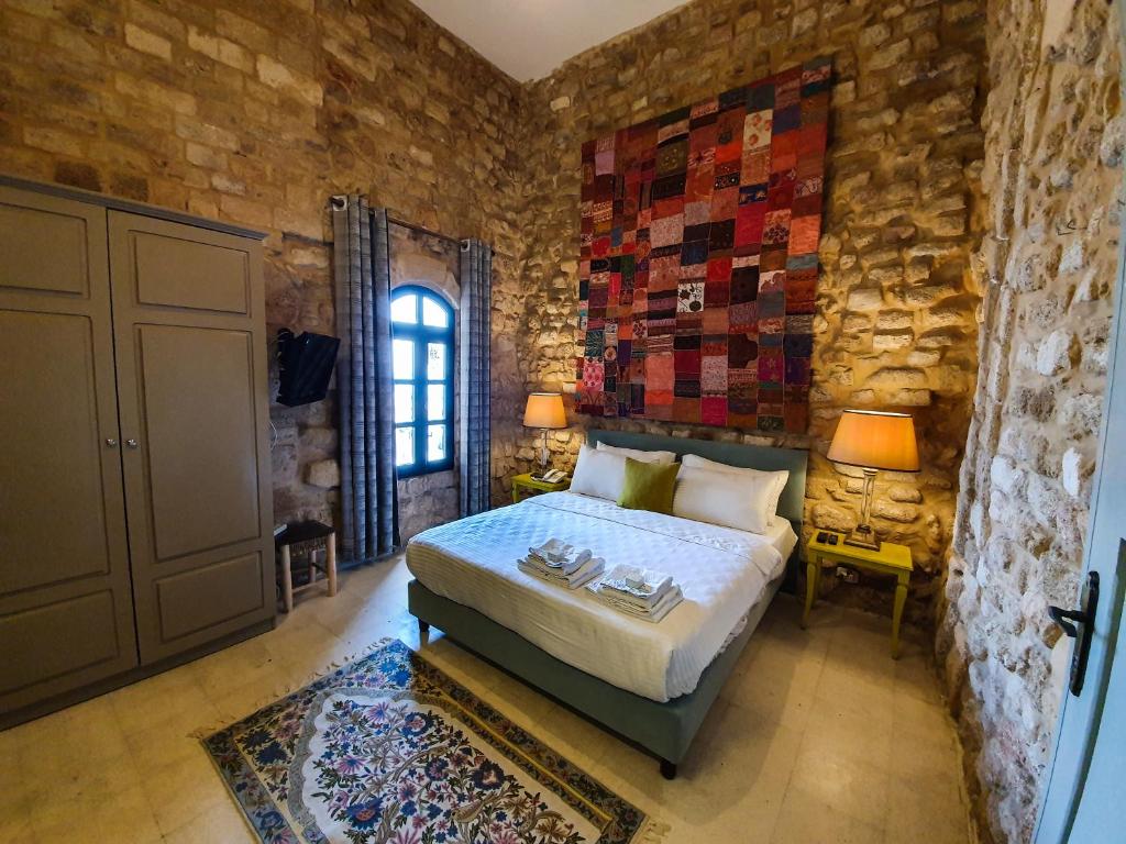 A bed or beds in a room at Al Qualaa Boutique Hotel