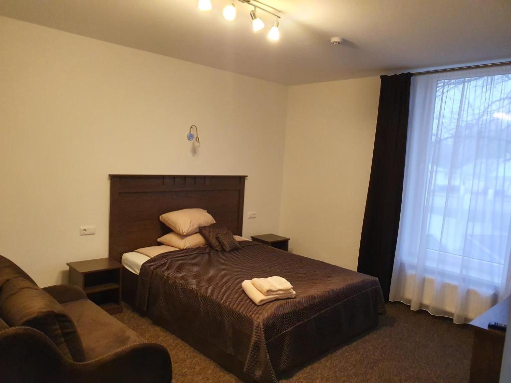 Postel nebo postele na pokoji v ubytování Svetainė