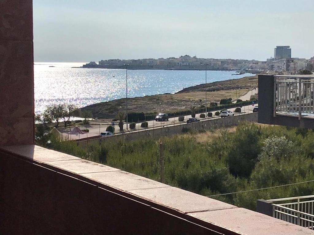 a view of the ocean from the balcony of a building at Trilocale Lalla sul mare in Gallipoli