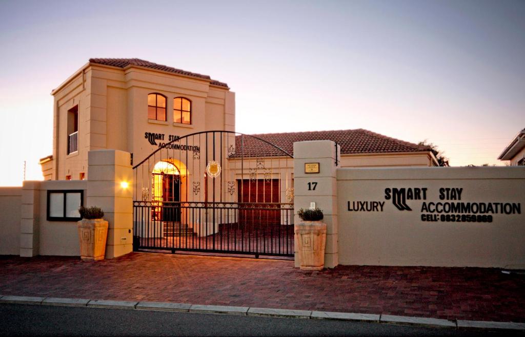 a house with a gate in front of it at A Smart Stay Apartments in Somerset West