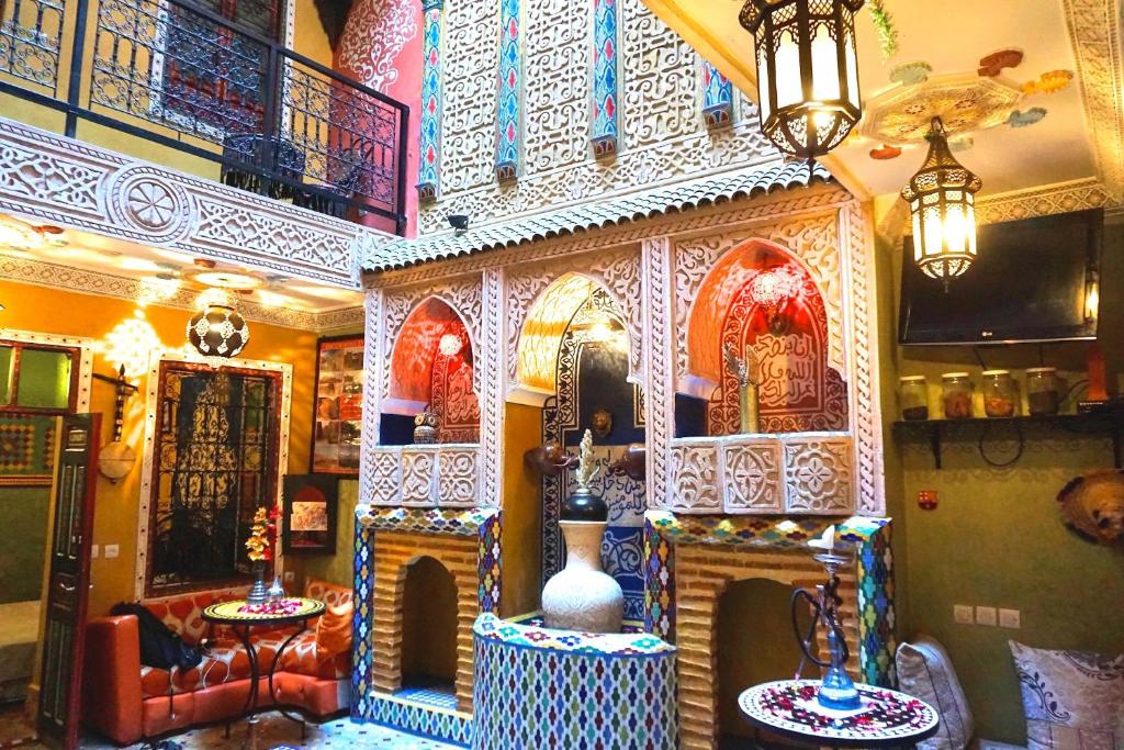 a room with a room with a fireplace in a building at Riad Jennah Rouge in Marrakesh