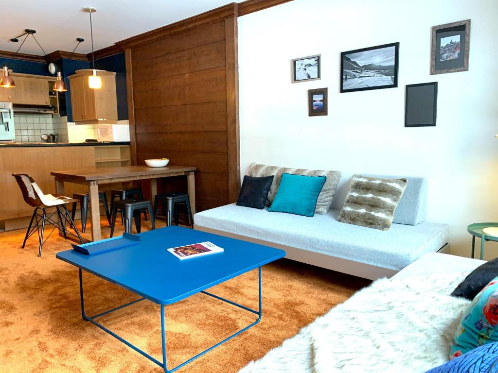 a living room with a couch and a table at Arc 1950 Manoir Savoie Skis aux pieds in Bourg-Saint-Maurice