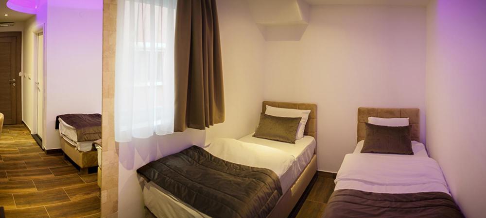 Postel nebo postele na pokoji v ubytování Olympic Wellness & Spa Hotel
