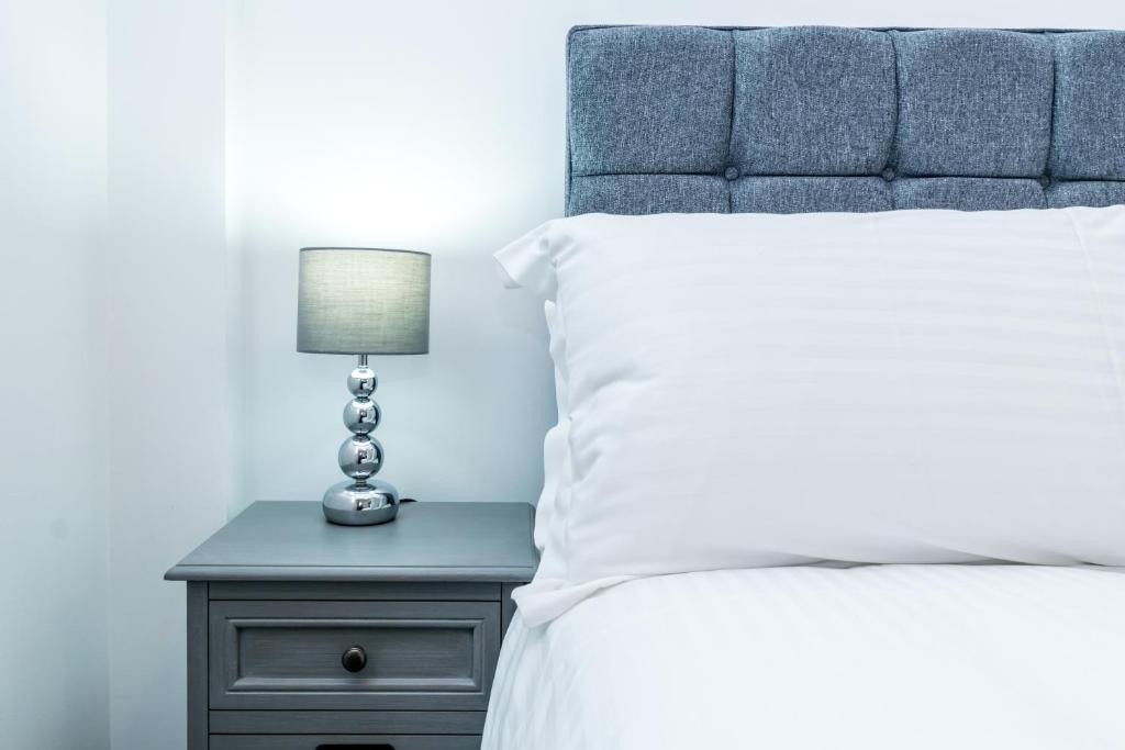 - une chambre avec un lit et une lampe sur une table de chevet dans l'établissement St Mary's Apartments, à York