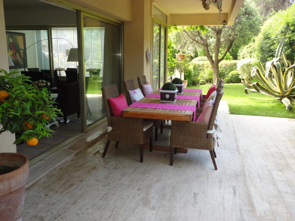a dining room table and chairs on a patio at B&B Villa Feline in Cannes