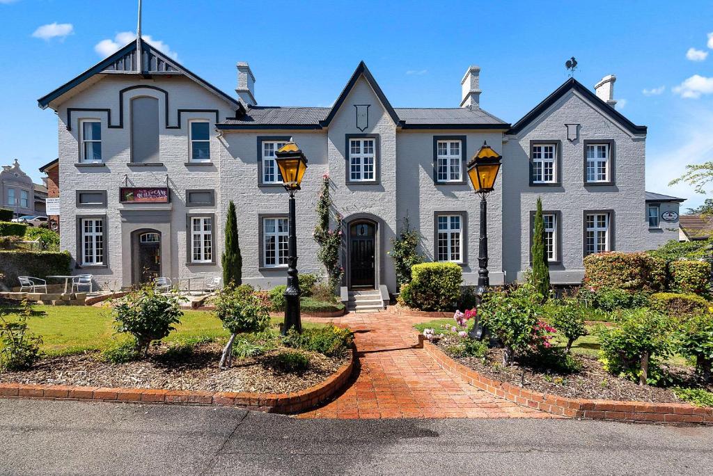 a large white house with a driveway at Quality Hotel Colonial Launceston in Launceston