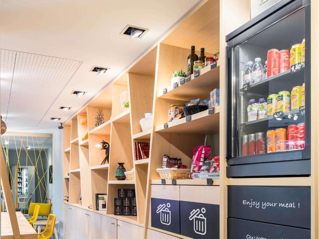 a room with shelves with drinks on them at Aparthotel Adagio Access Paris Porte De Charenton in Charenton-le-Pont