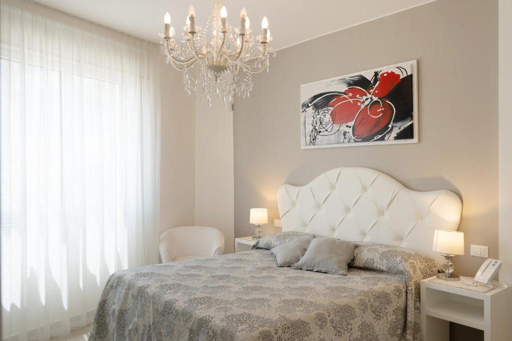 a bedroom with a bed and a chandelier at Bellariva Monopoli B&B e Relax in Monopoli