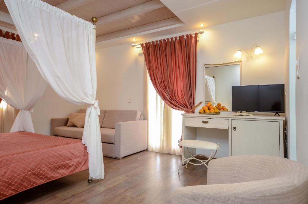 a bedroom with a bed and a television at Aeolis Boutique Hotel in Naxos Chora