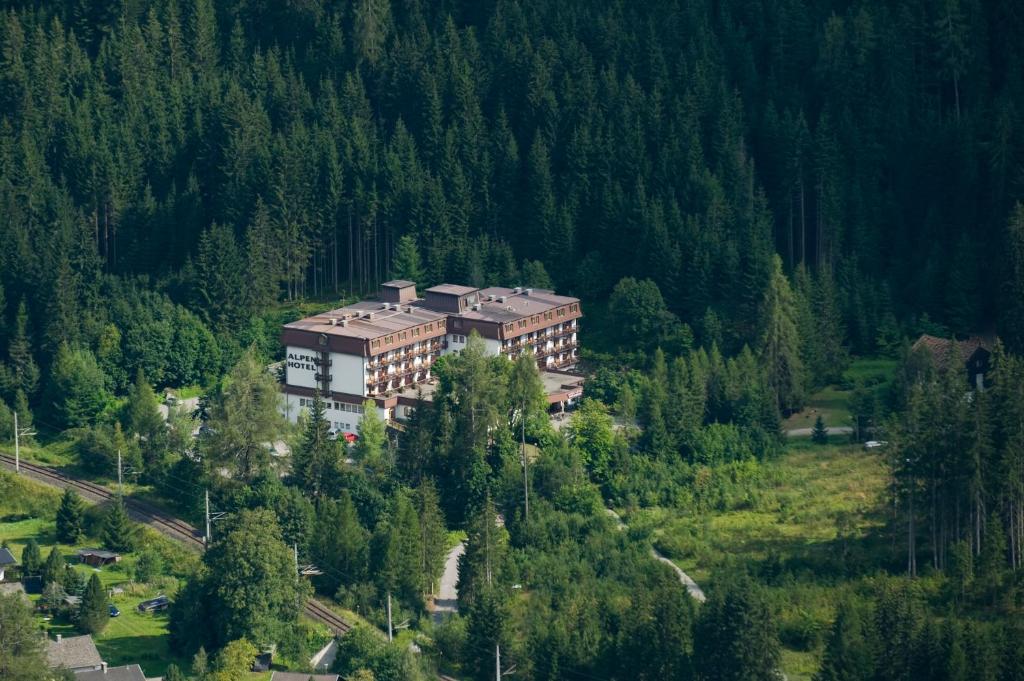 a large building in the middle of a forest at Alpenhotel Weitlanbrunn in Sillian