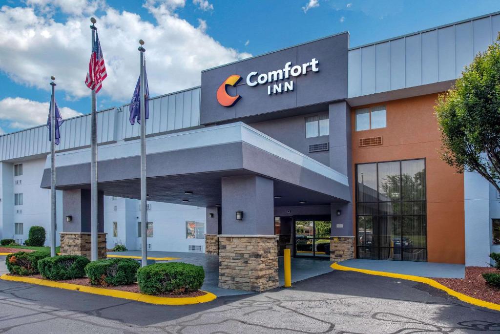 a corner inn building with flags in front of it at Comfort Inn South in Indianapolis