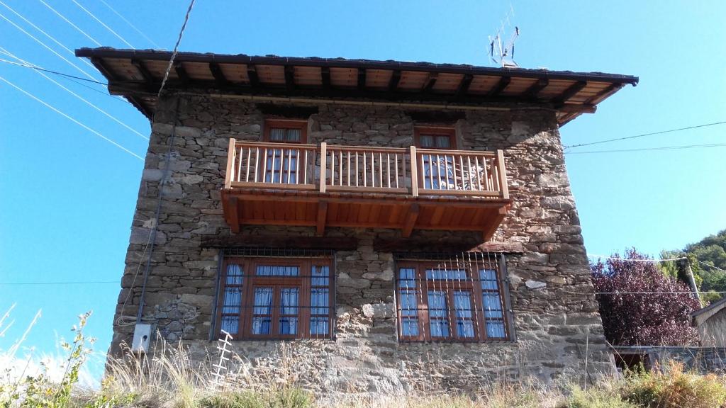 a building with a balcony on top of it at La vieille école in Montjovet