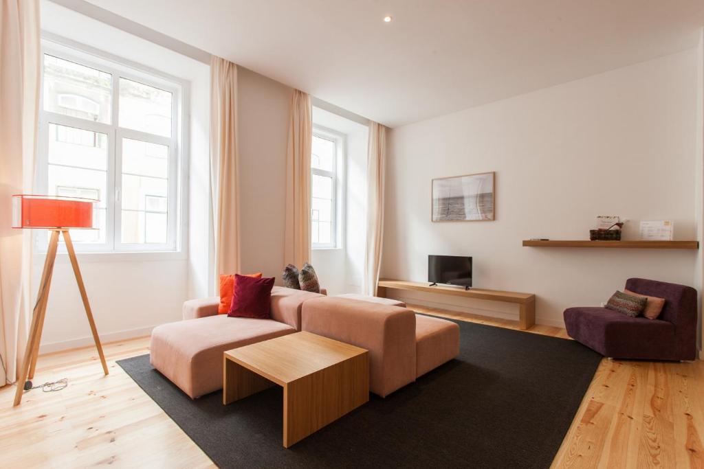 a living room with a couch and a chair at FLH Baixa Luxury Apartment in Lisbon