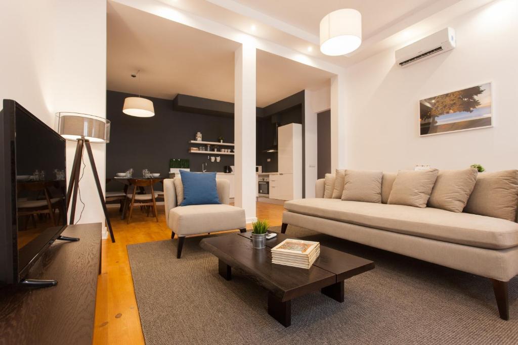 a living room with a couch and a table at FLH Luxus Baixa Flat in Lisbon