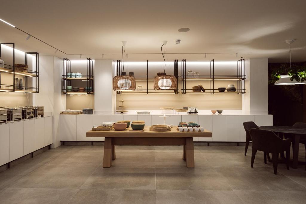 a kitchen with a table with bowls on it at Hotel Juliani - Boutique Hotel in St. Julianʼs