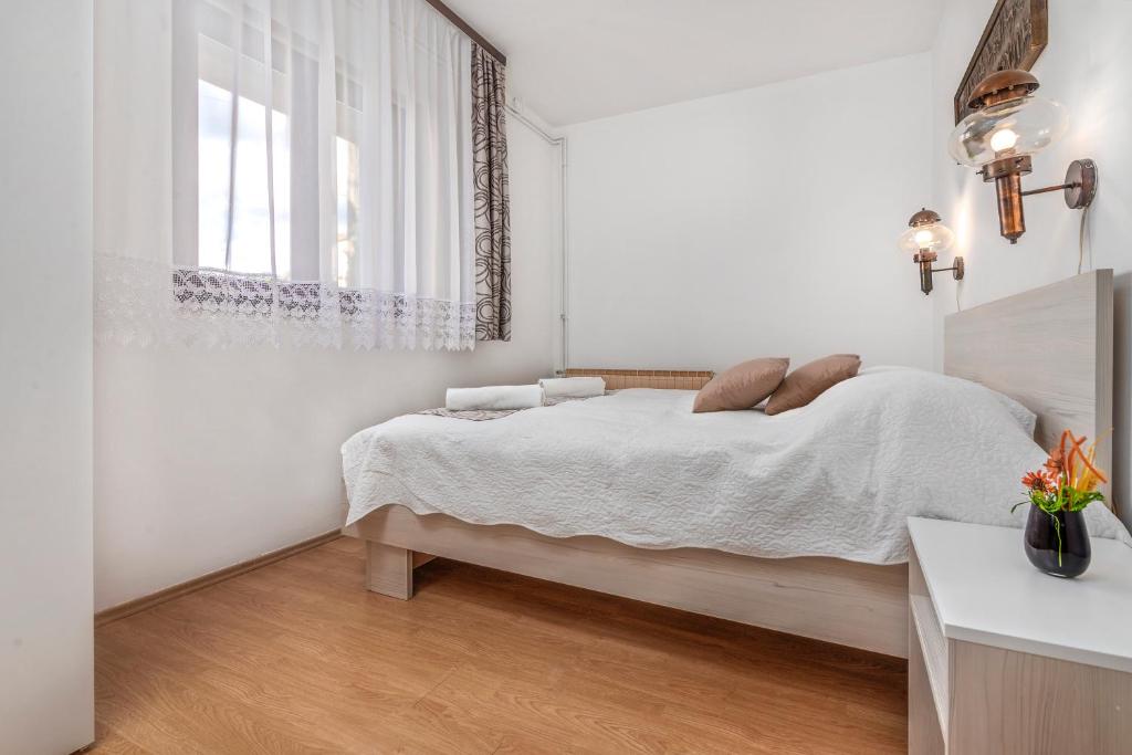 Postel nebo postele na pokoji v ubytování Apartments Vera Savic