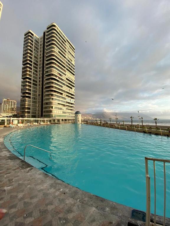 a large swimming pool in front of some tall buildings at Condominio Mar Egeo Iquique in Iquique