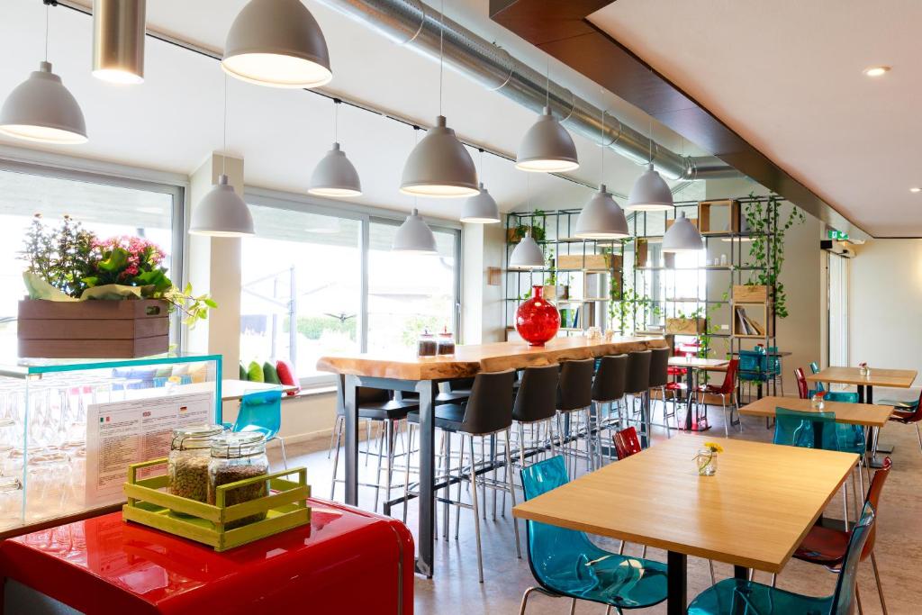 a restaurant with tables and chairs at Hotel Oleggio Malpensa in Oleggio