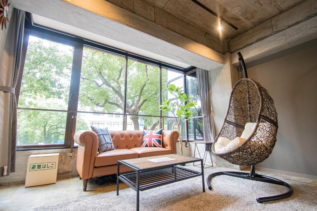 a living room with a couch and a chair at ARK NISHIJIN 2 / Vacation STAY 57345 in Fukuoka