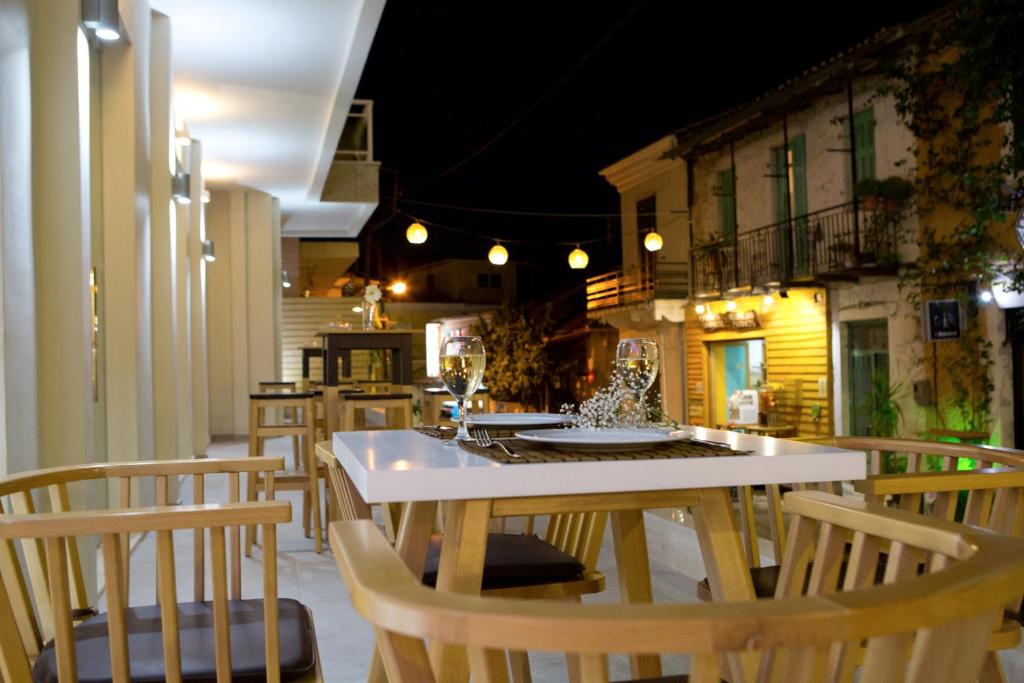 a kitchen with a table and chairs in a room at Grand TheoNi Boutique Hotel & Spa in Vasiliki