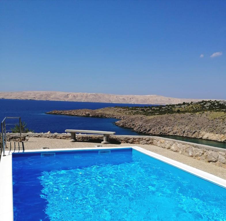 a swimming pool with a view of the water at Villa Mihaela - Apartment Ika in Cesarica