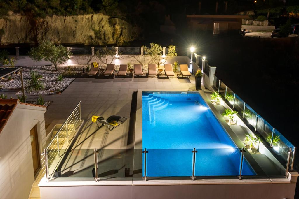 an overhead view of a swimming pool at night at Apartments Tina in Split