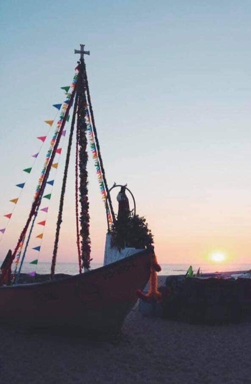 a boat on the beach with flags on it at Casa da Fátima, in Vila Chã