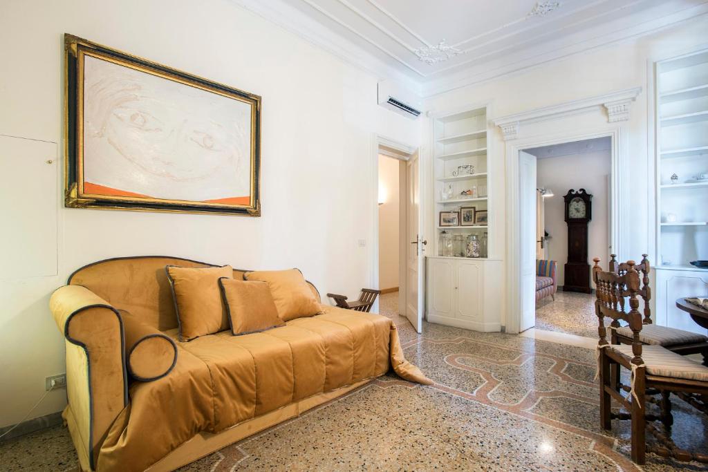 a living room with a couch and a picture on the wall at Flat Two in Rome