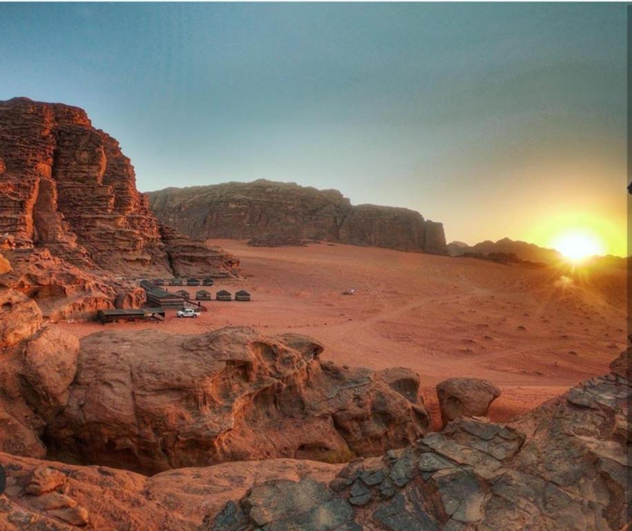 a rocky area with rocks and a cliff at Beyond Wadi Rum Camp in Wadi Rum