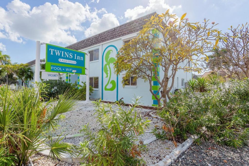 a building with a sign in front of it at Twins Inn & Apartments in St Pete Beach