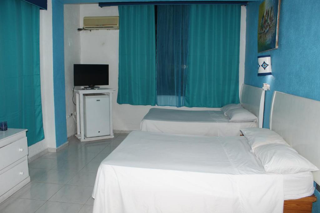 Postel nebo postele na pokoji v ubytování Aparta Hotel Azzurra