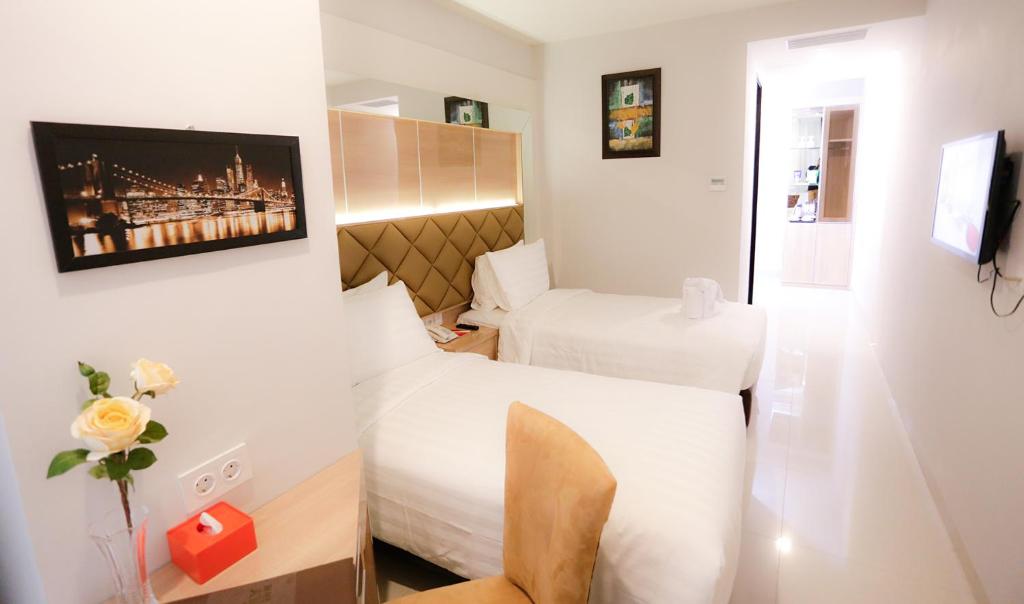 Tempat tidur dalam kamar di Hotel Daily Inn