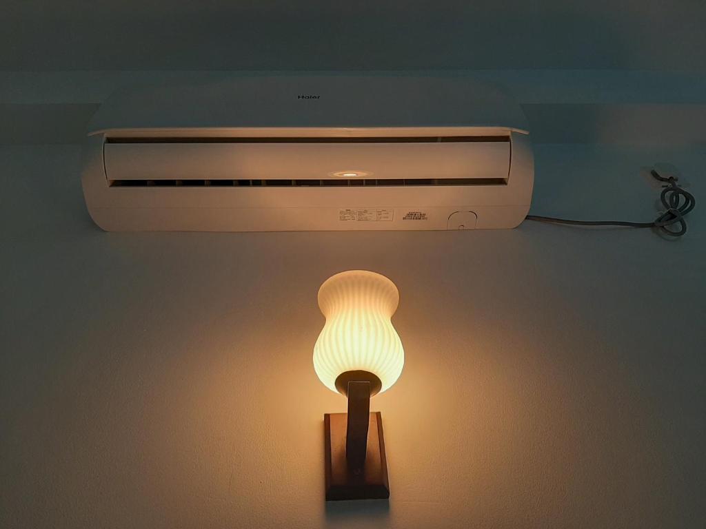 a light that is next to a heater at Hill House Rest in Mirissa