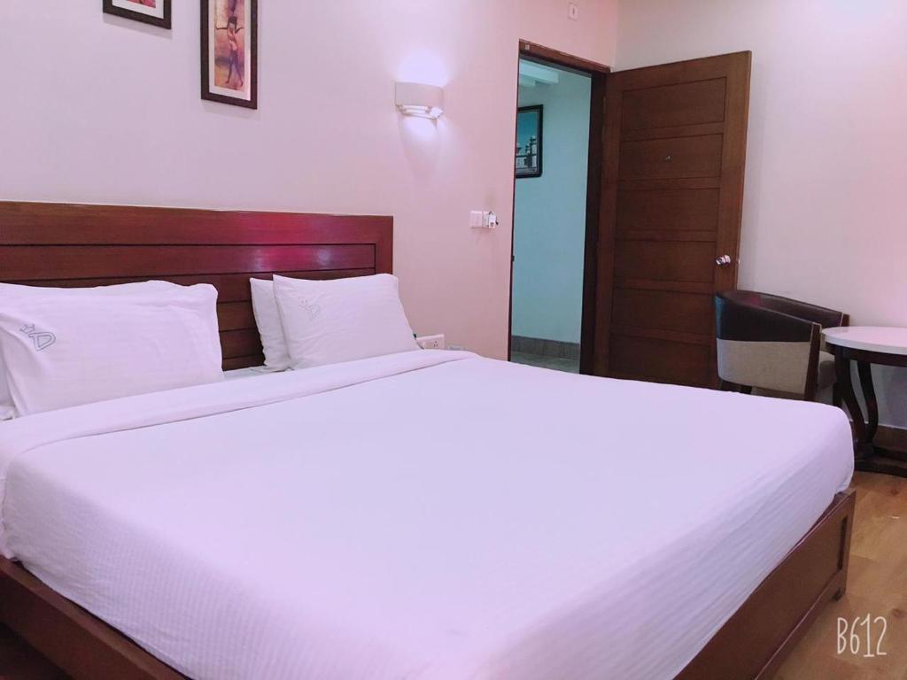 Postel nebo postele na pokoji v ubytování Hotel Dasaprakash