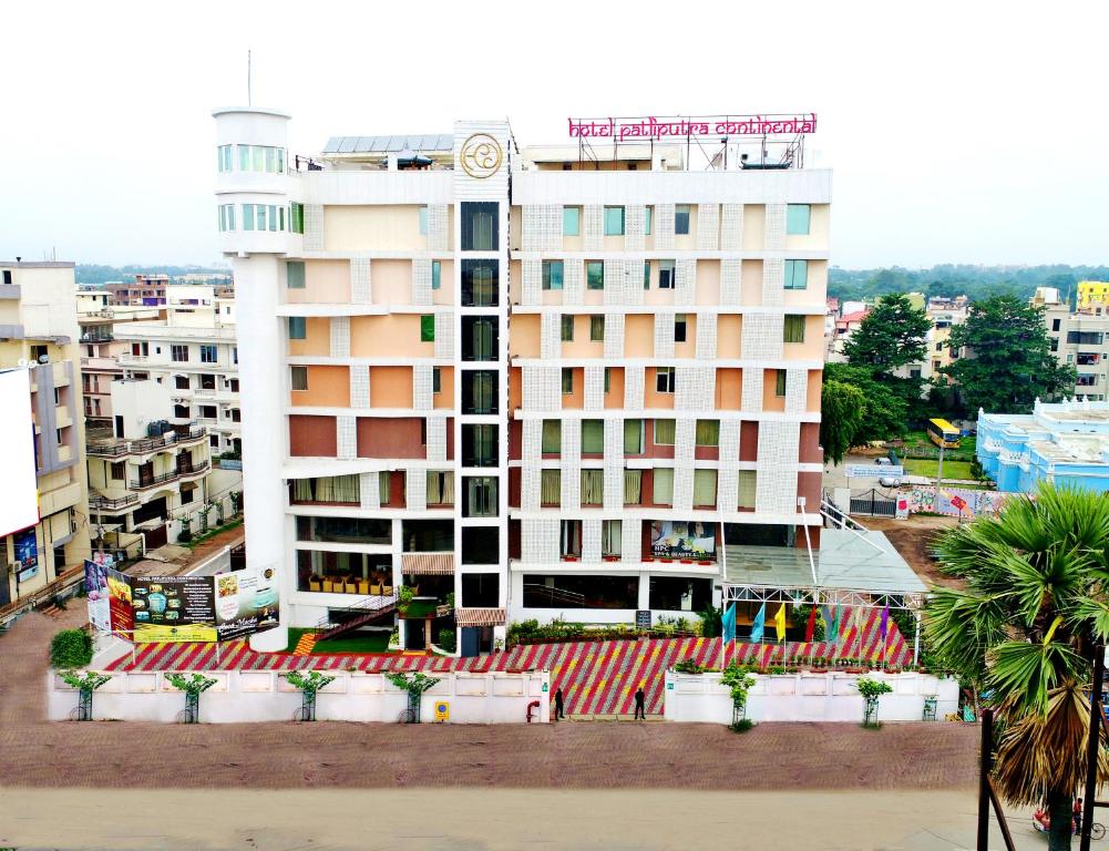 a white building with a clock on top of it at Hotel Patliputra Continental in Patna